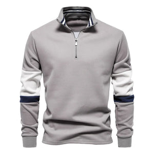 Gray zip-neck sweatshirt with colorblock sleeves and striped collar detail.