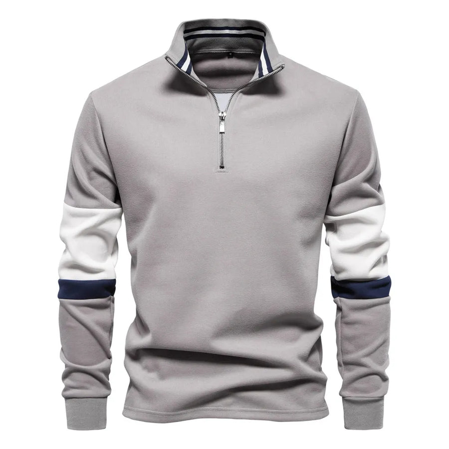 Gray zip-neck sweatshirt with colorblock sleeves and striped collar detail.