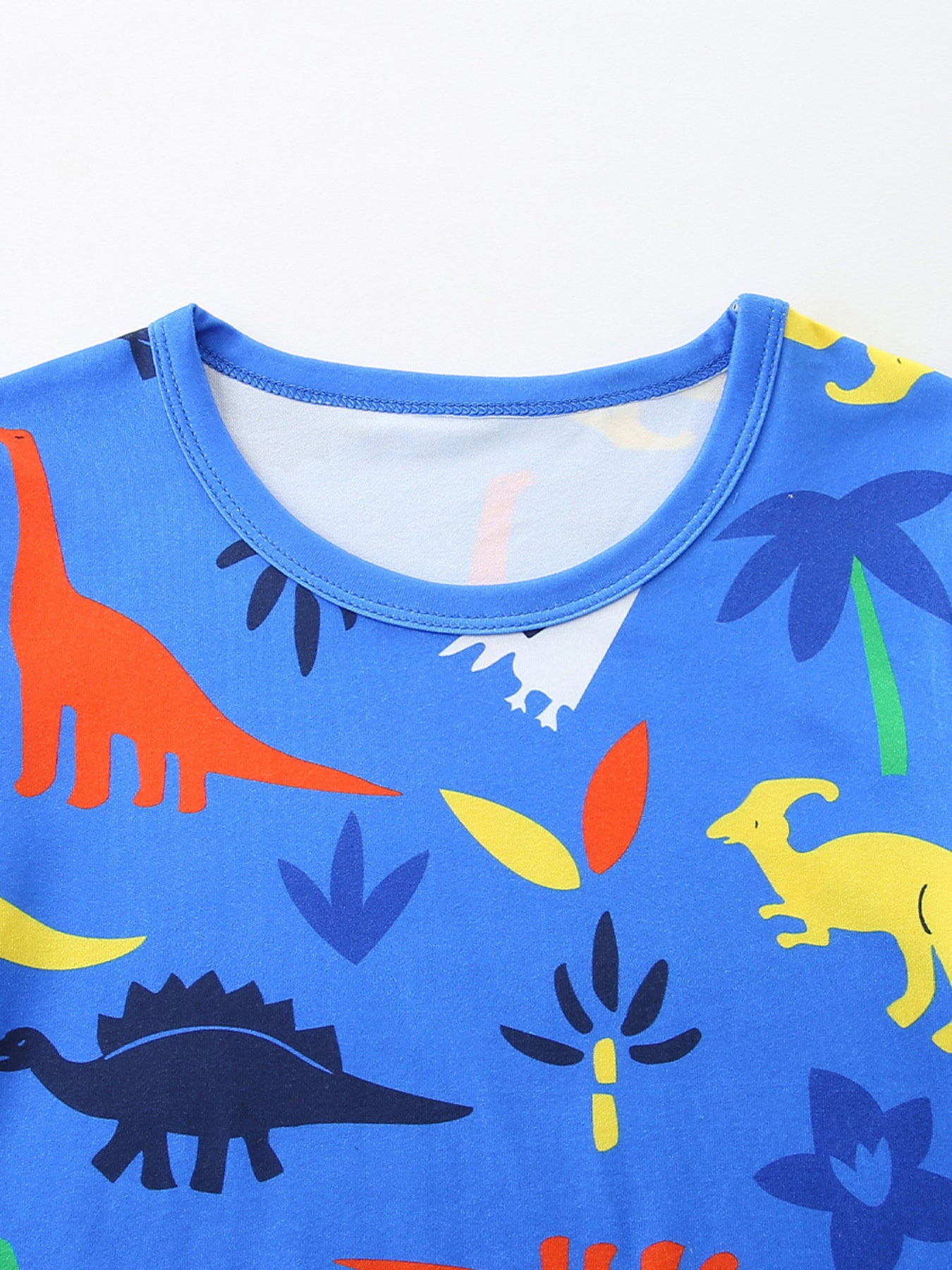Blue toddler tee with a colorful dinosaur and palm tree print.