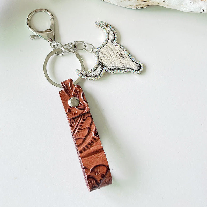 Western keychain with embossed leather strap and crystal bull skull charm