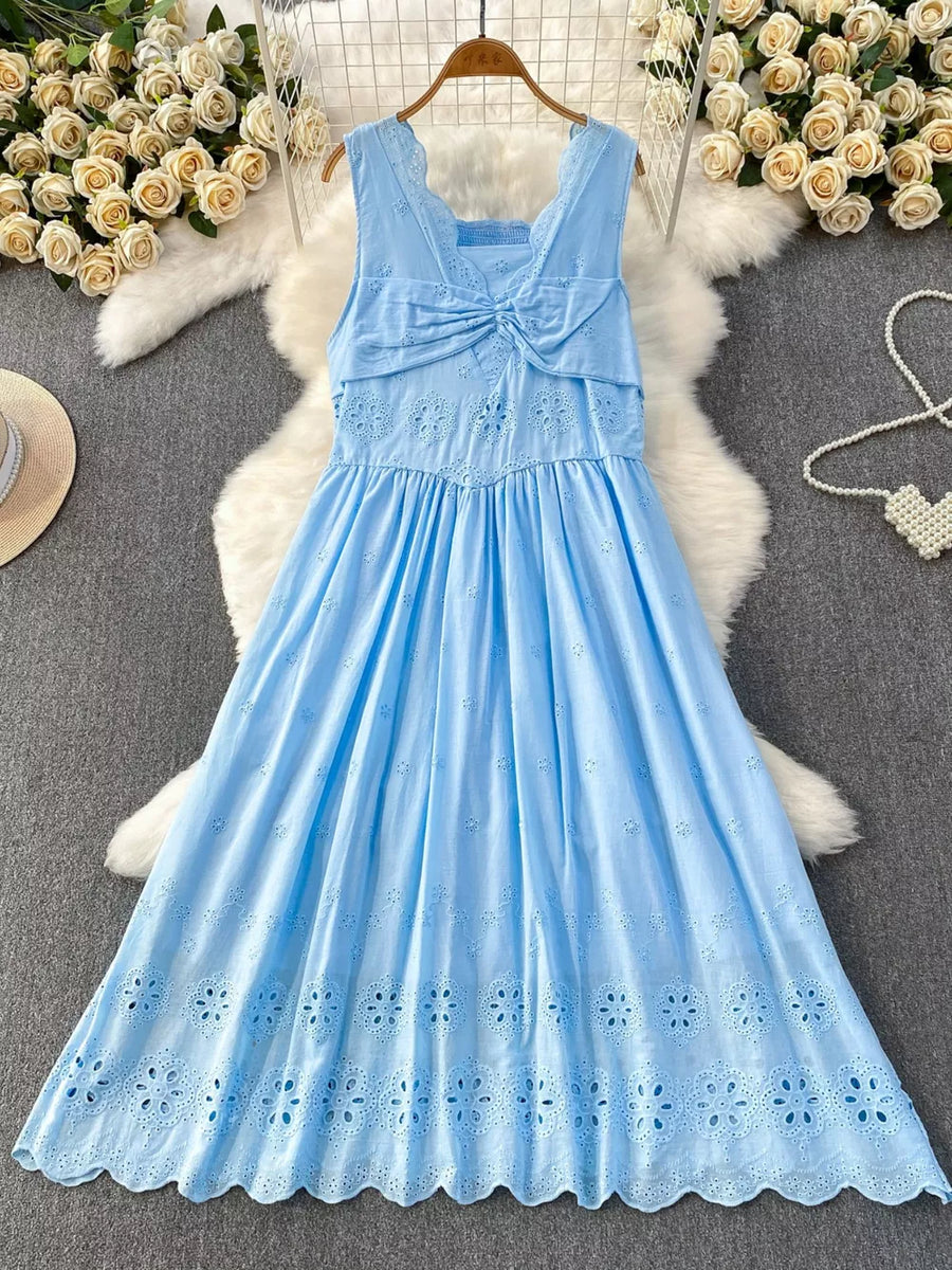 Blue eyelet maxi dress with cutout detail and knotted bodice.