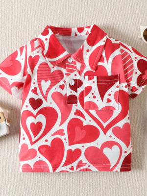 Red and white heart print cotton polo shirt with short sleeves and a chest pocket.