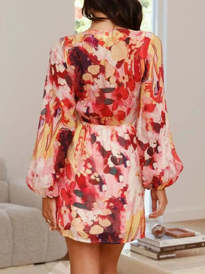 V-neck tie waist dress with abstract floral print and balloon sleeves.