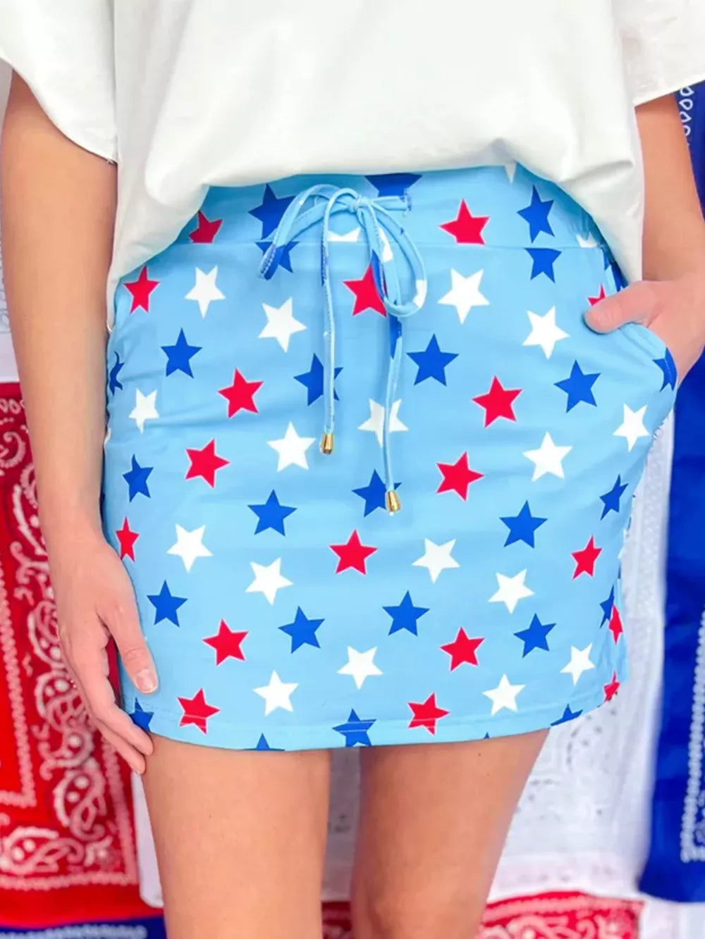 Starry drawstring mini skort with pockets in blue with red and white stars.