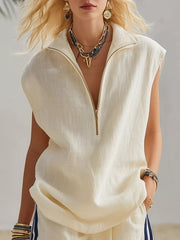 Cream linen sleeveless zip-neck top with gold zipper and collar