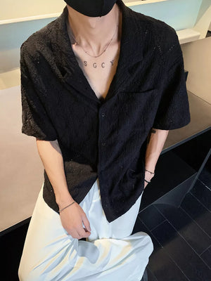 Textured knit short-sleeve black men's shirt with classic collar and button front.