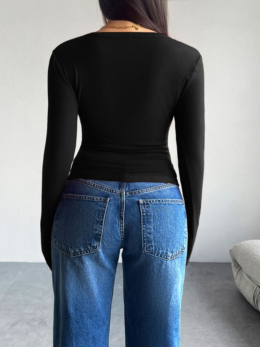 Black button-up cardigan with long sleeves, shown from the back.