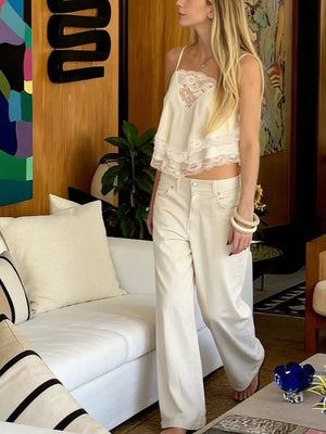 Cream camisole with lace trim and delicate neckline, cropped flowy fit