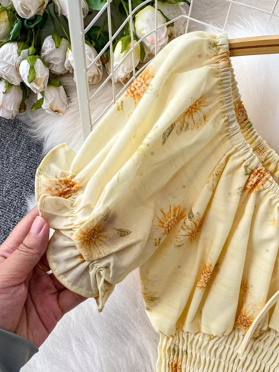 Floral ruffled crop top with puff sleeves and smocked waist in yellow chiffon.