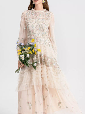 Embroidered floral tulle maxi gown with ruffled tiers and long sleeves.