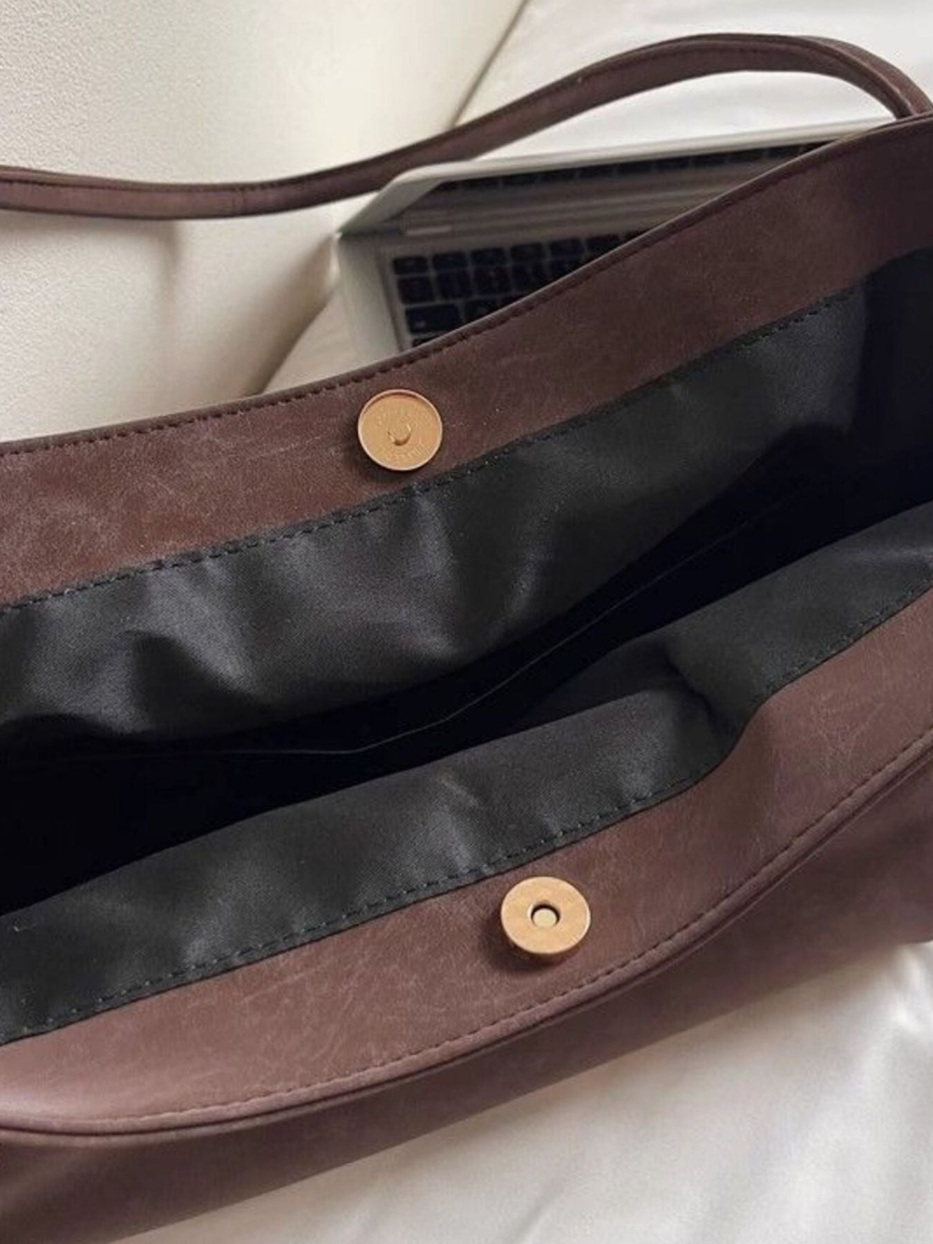 Large brown suede shoulder bag with magnetic snap closure and black lining.