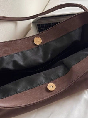 Large brown suede shoulder bag with magnetic snap closure and black lining.