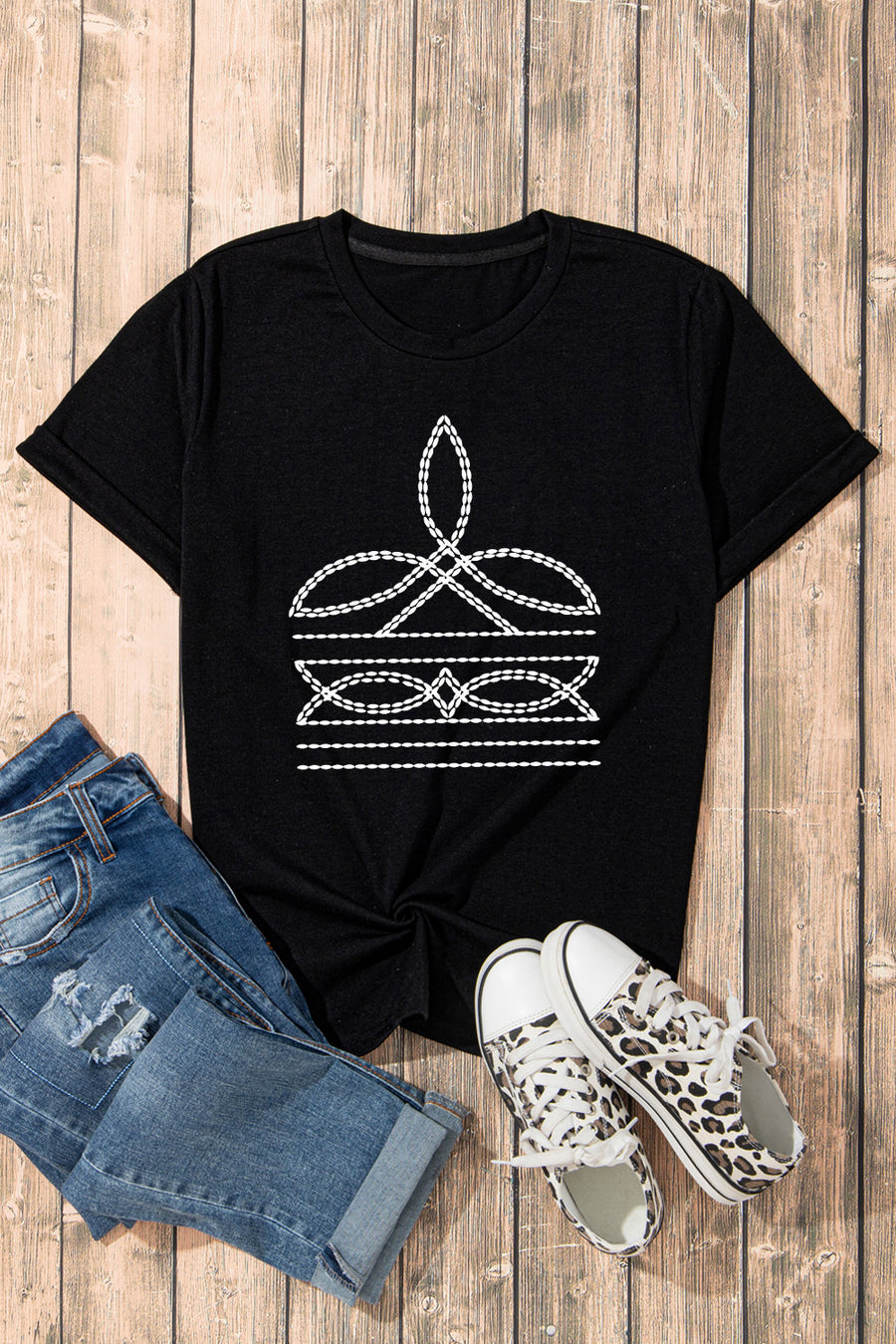 Black crew neck t-shirt with white embroidered graphic detail and rolled sleeves.