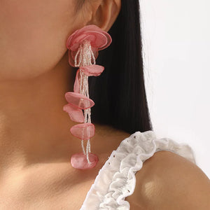 White earrings featuring beaded and floral
