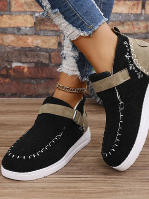 Black textured stitch-detail buckle sneakers with contrast stitching and tan strap.