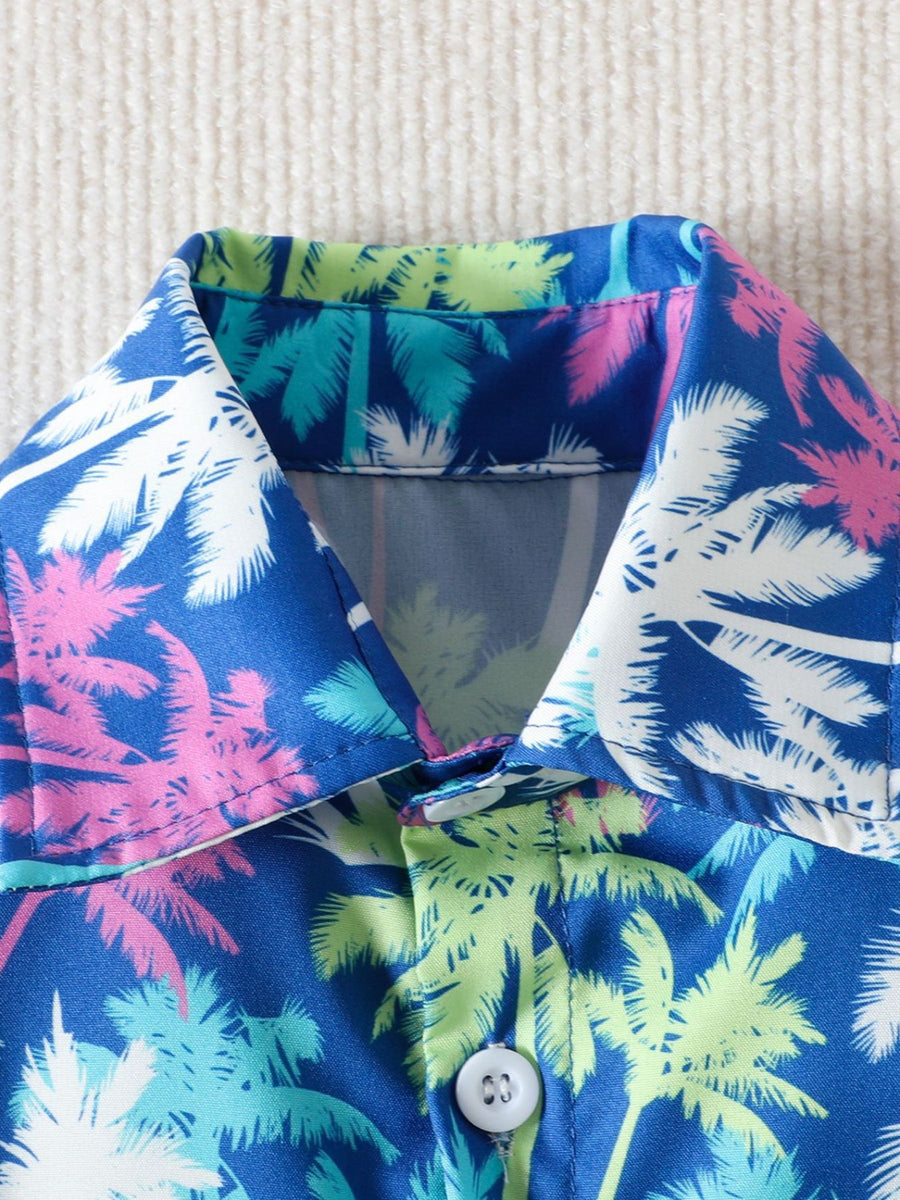 Toddler collared shirt with tropical palm tree print in blue, green, pink, and white cotton.