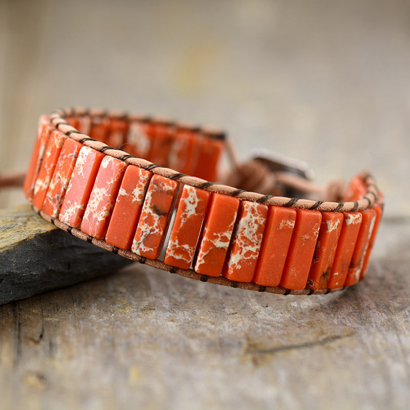 Jasper wrap bracelet in orange with white marbling on leather cord.