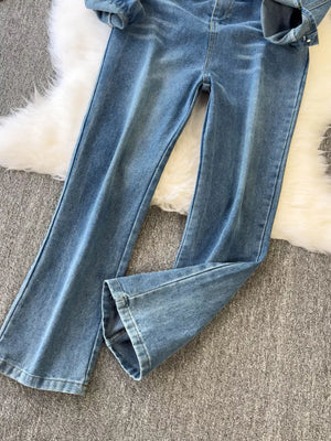 Chic buttoned denim jumpsuit with pockets in a light wash cotton blend.