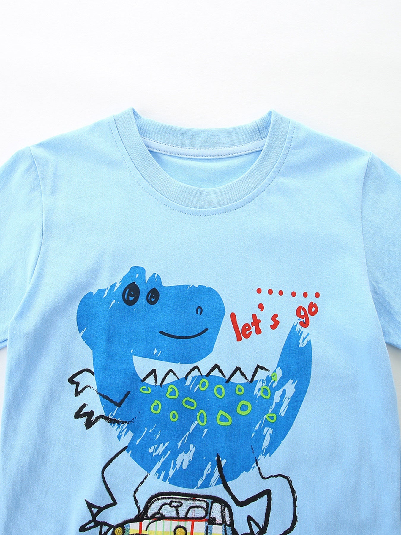 Light blue cotton t-shirt with a blue dinosaur graphic and "let's go" text.