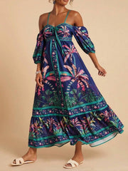 Navy tropical print maxi dress with smocked bodice, cold shoulder sleeves, and tie front.