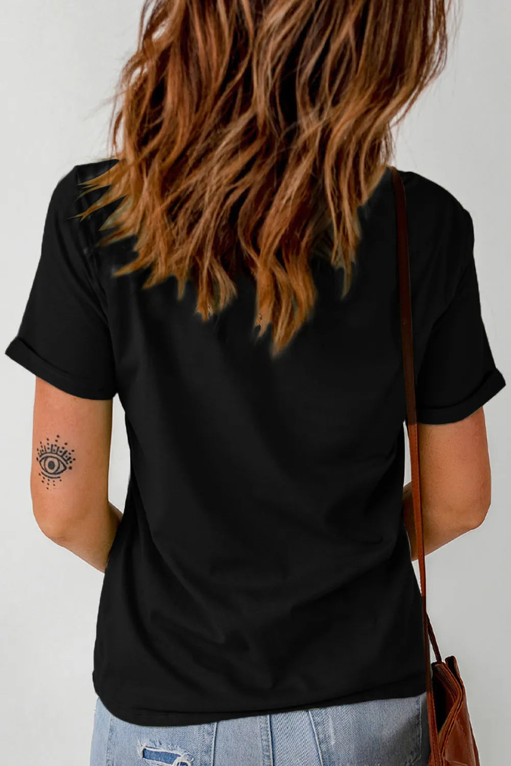 Black graphic tee with short sleeves and a rolled cuff, featuring a leopard-print "Thankful" design.