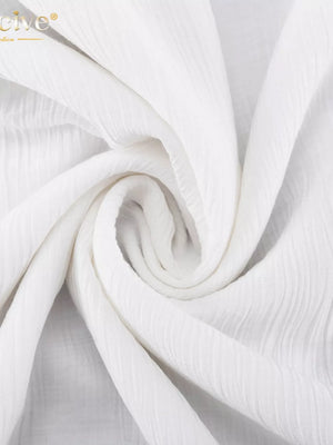 White textured crinkle fabric with a subtle vertical stripe pattern.