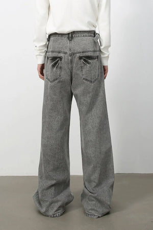 Wide-leg washed denim jeans in dark gray with a belt detail and relaxed fit.