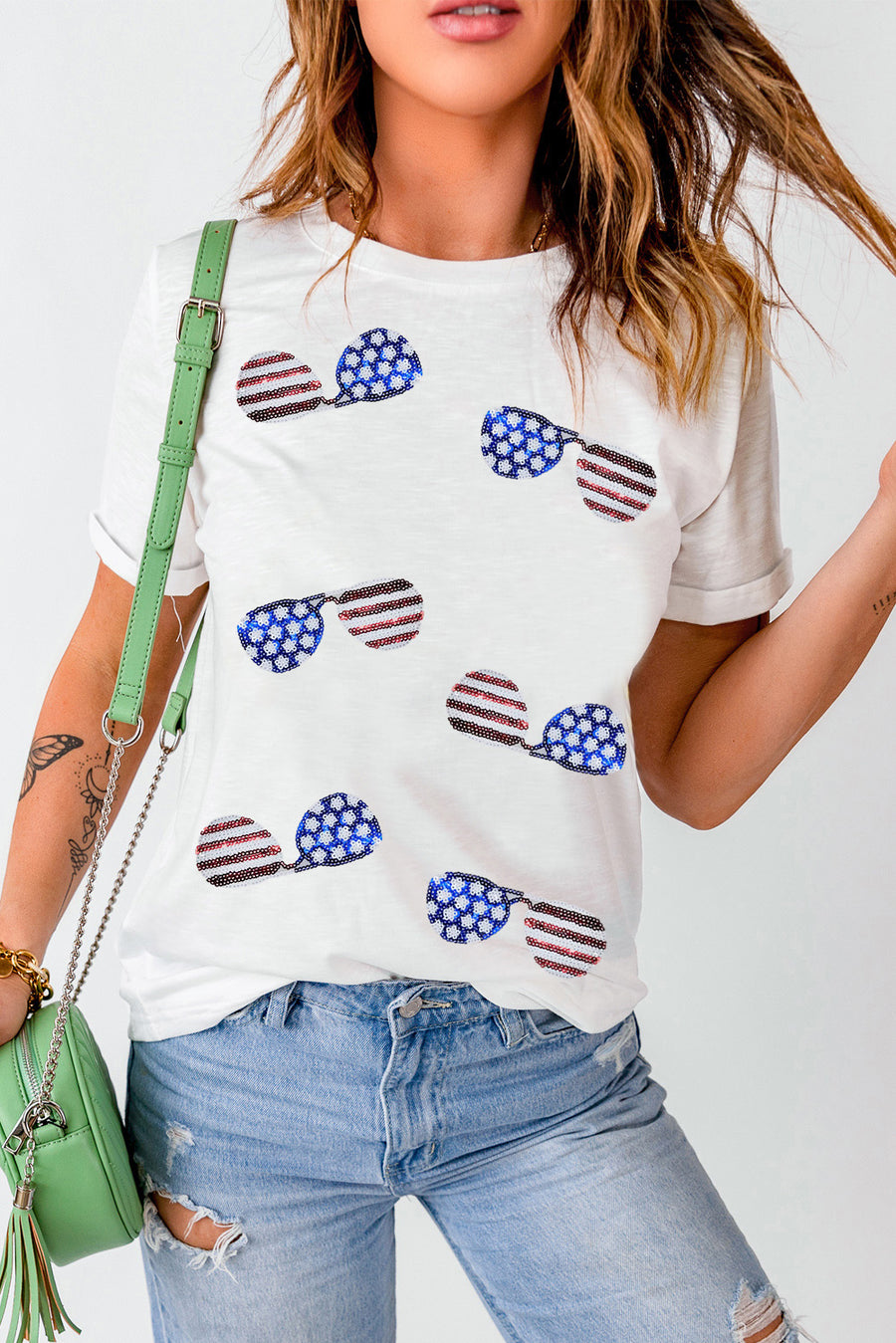 White t-shirt with all-over sequin American flag sunglasses graphic, crew neck, short sleeves.
