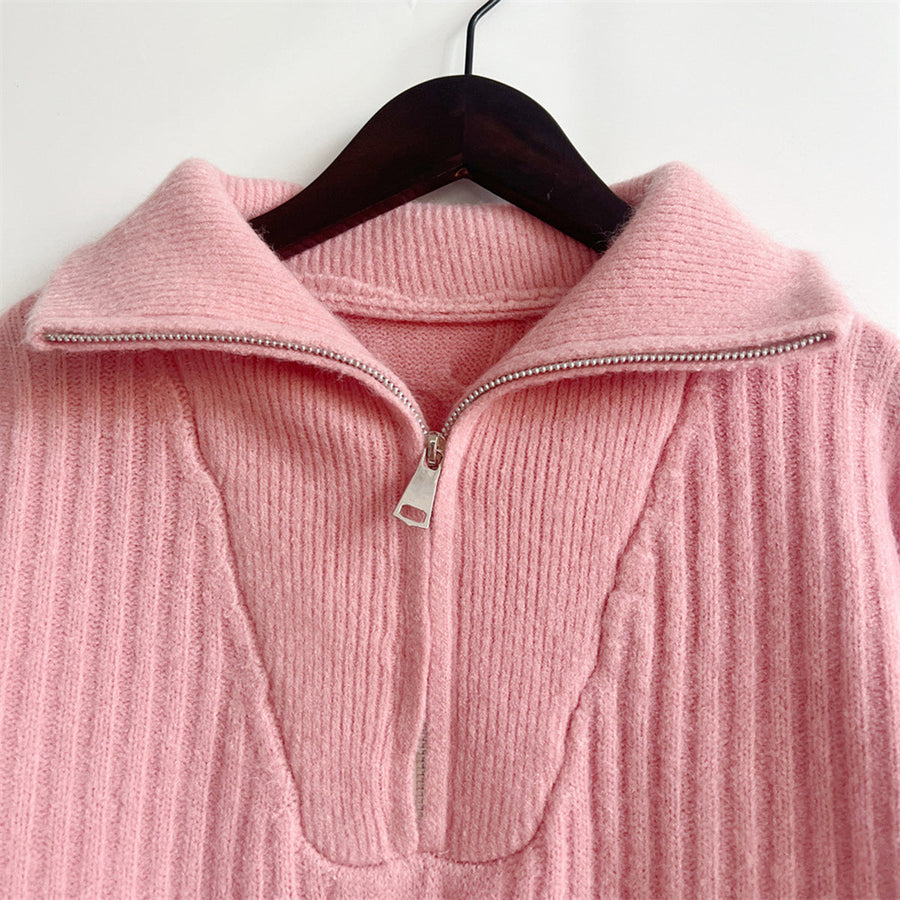 Dusty pink cable knit zip-neck sweater with a ribbed texture and silver zipper detail.