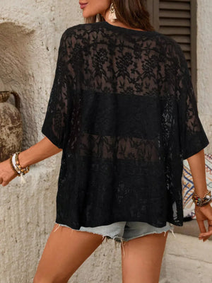 Black floral lace sheer top with lace trim and short sleeves, styled with denim shorts.