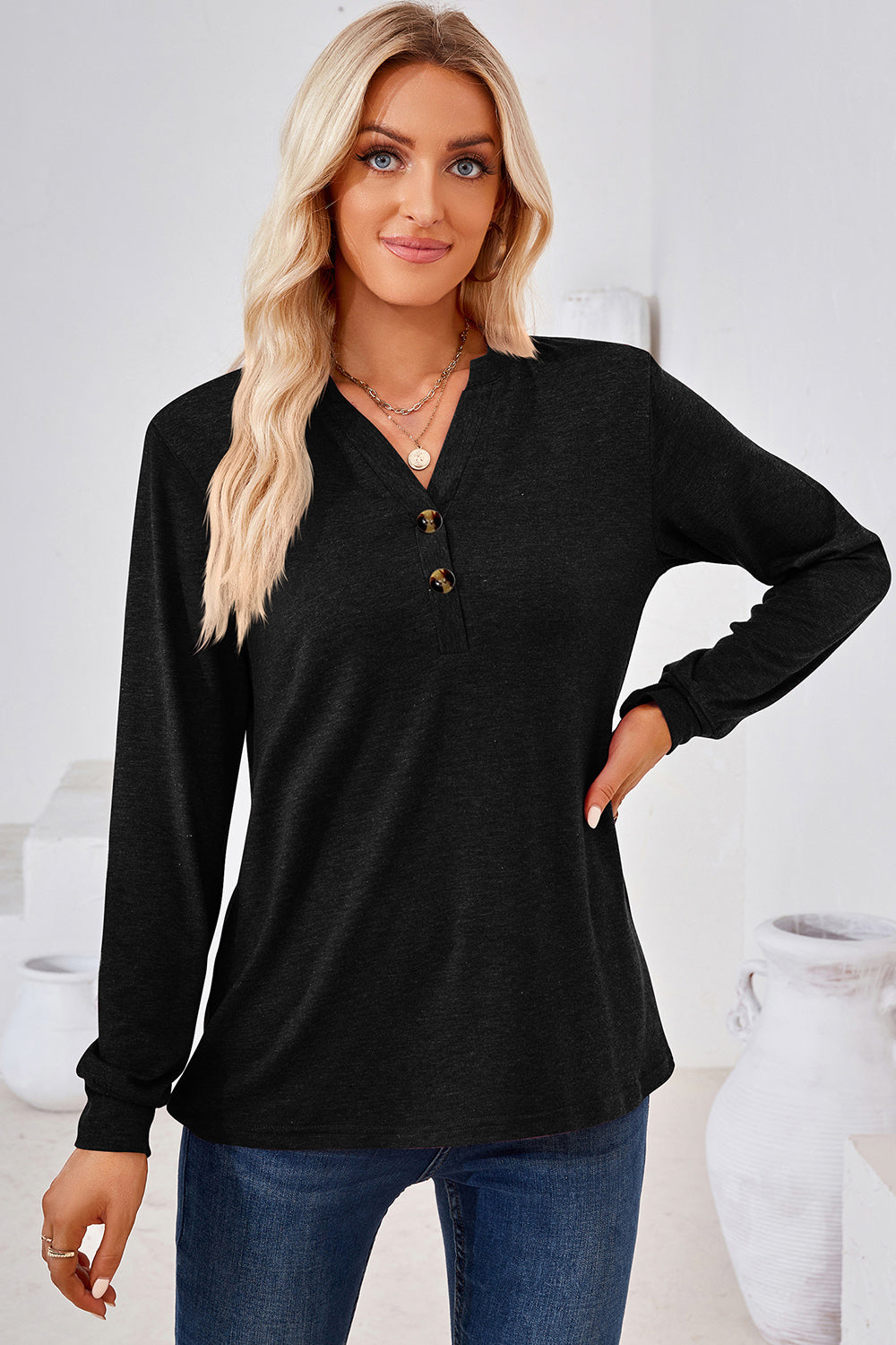 Black Henley button-down knit top with long sleeves and a V-neck.