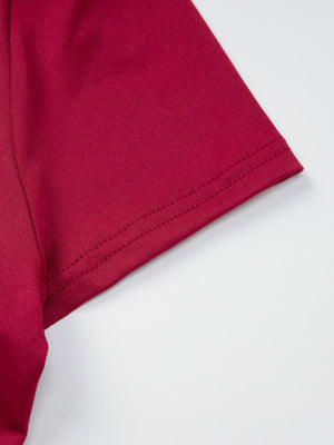 Fitted one-shoulder t-shirt in deep red with double-stitched hem detail.