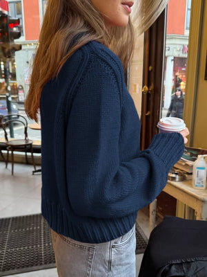 Navy ribbed round-neck knit sweater with cuffed sleeves and hem.