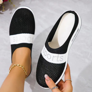 Black mesh slip-on athletic shoes with white "SPORTS" detail and air cushion sole.