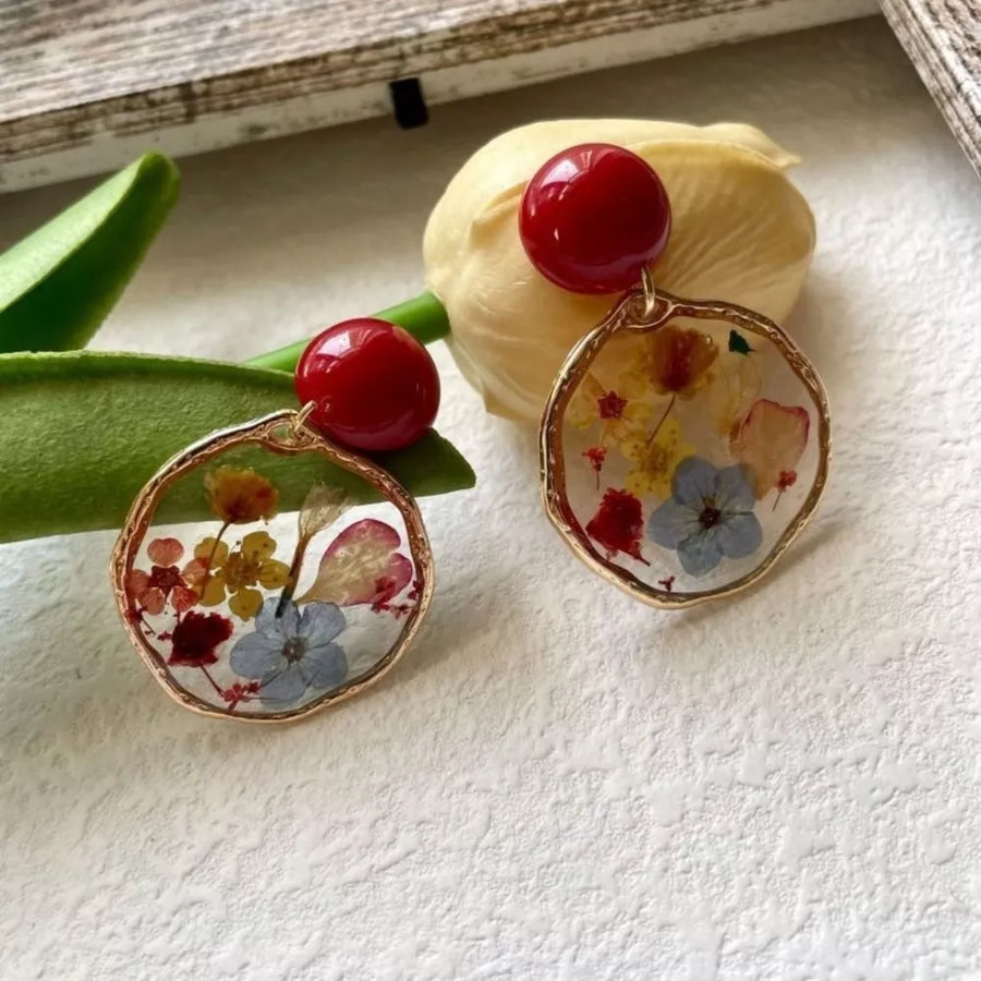 gold earrings featuring dangle and floral