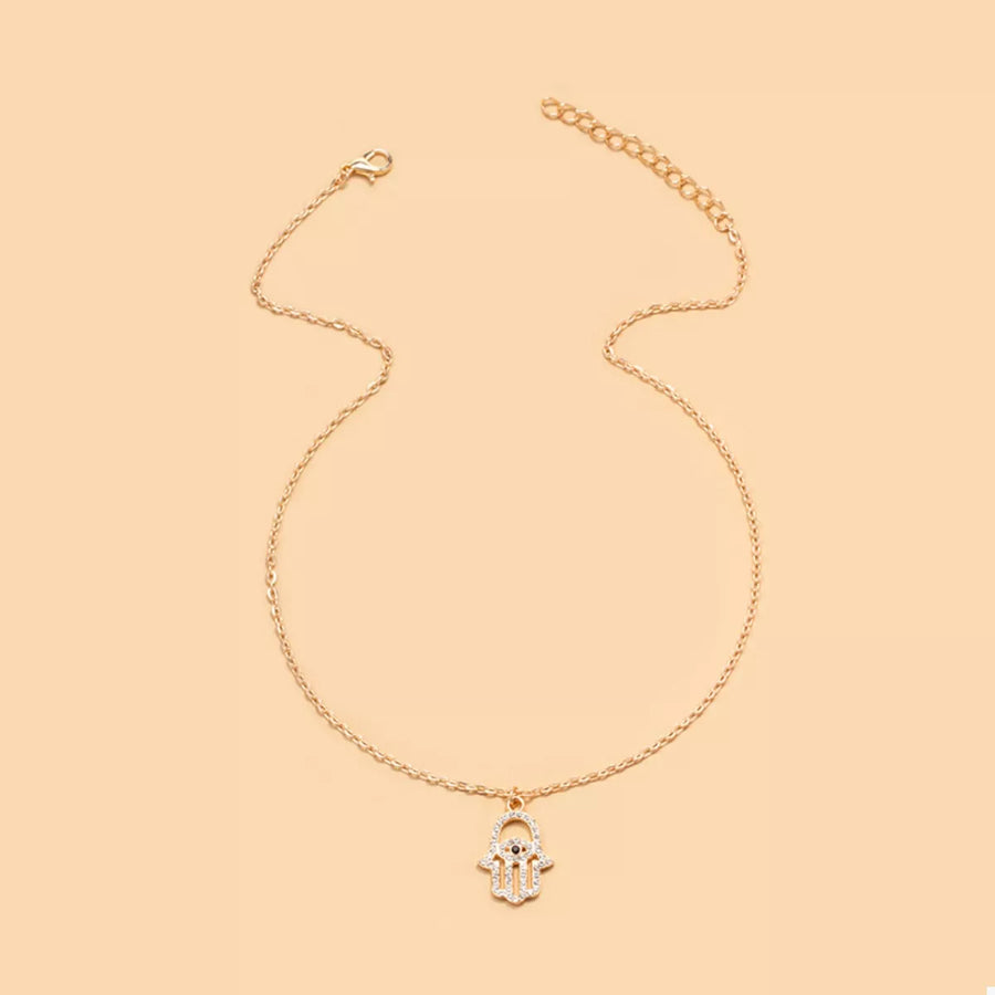 Gold evil eye hamsa pendant necklace with rhinestone details