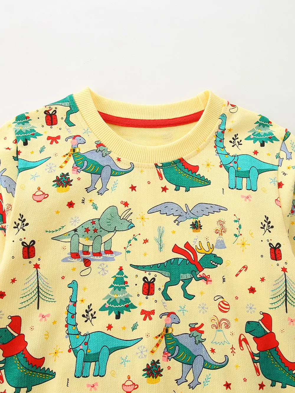 Yellow cotton crew neck sweatshirt with festive dinosaur Christmas print.
