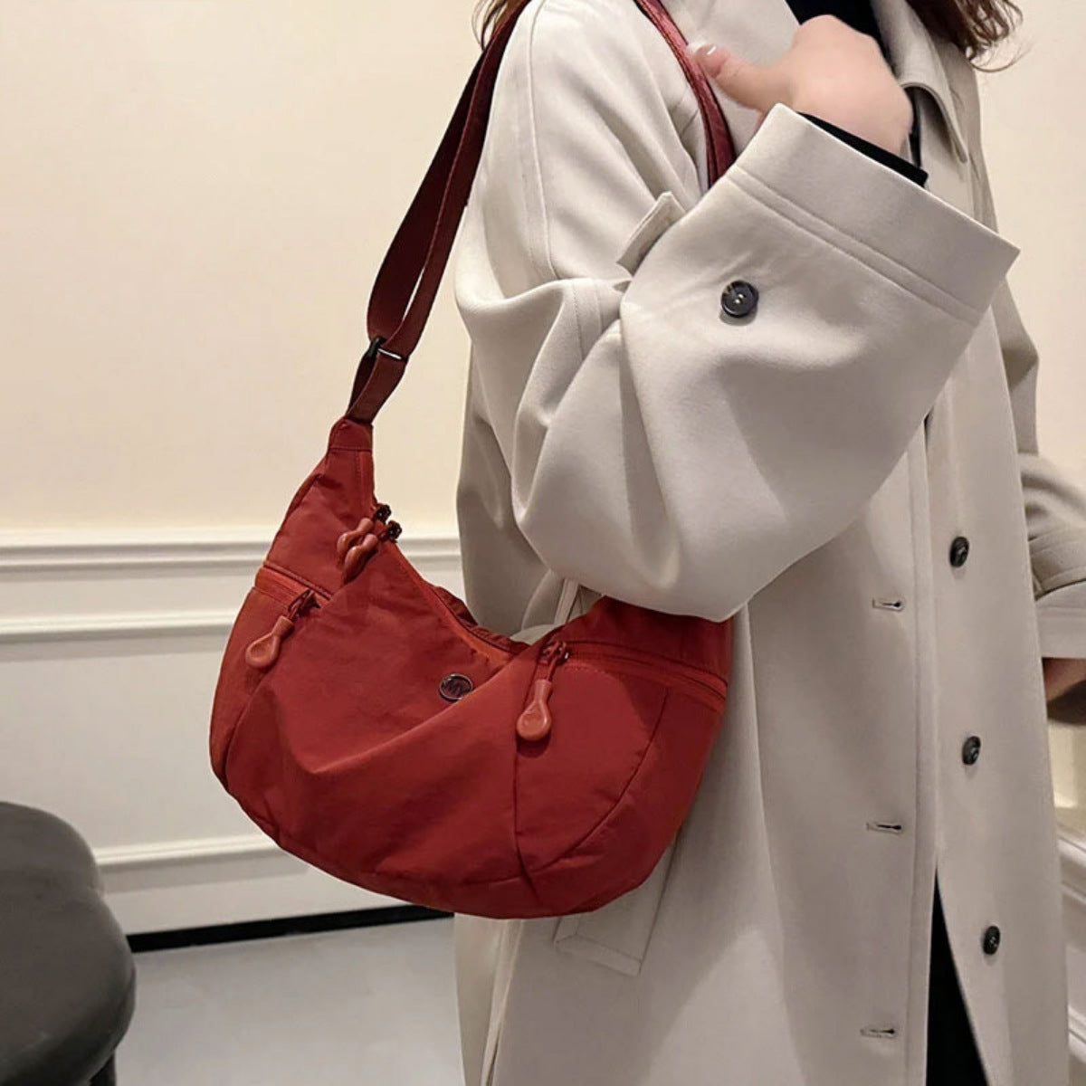 Red nylon crossbody bag with adjustable strap and zippered pockets