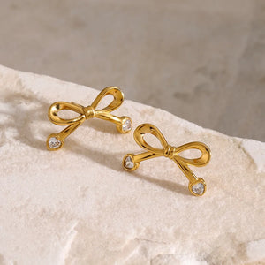 Gold cubic zirconia bow stud earrings with heart-shaped stones