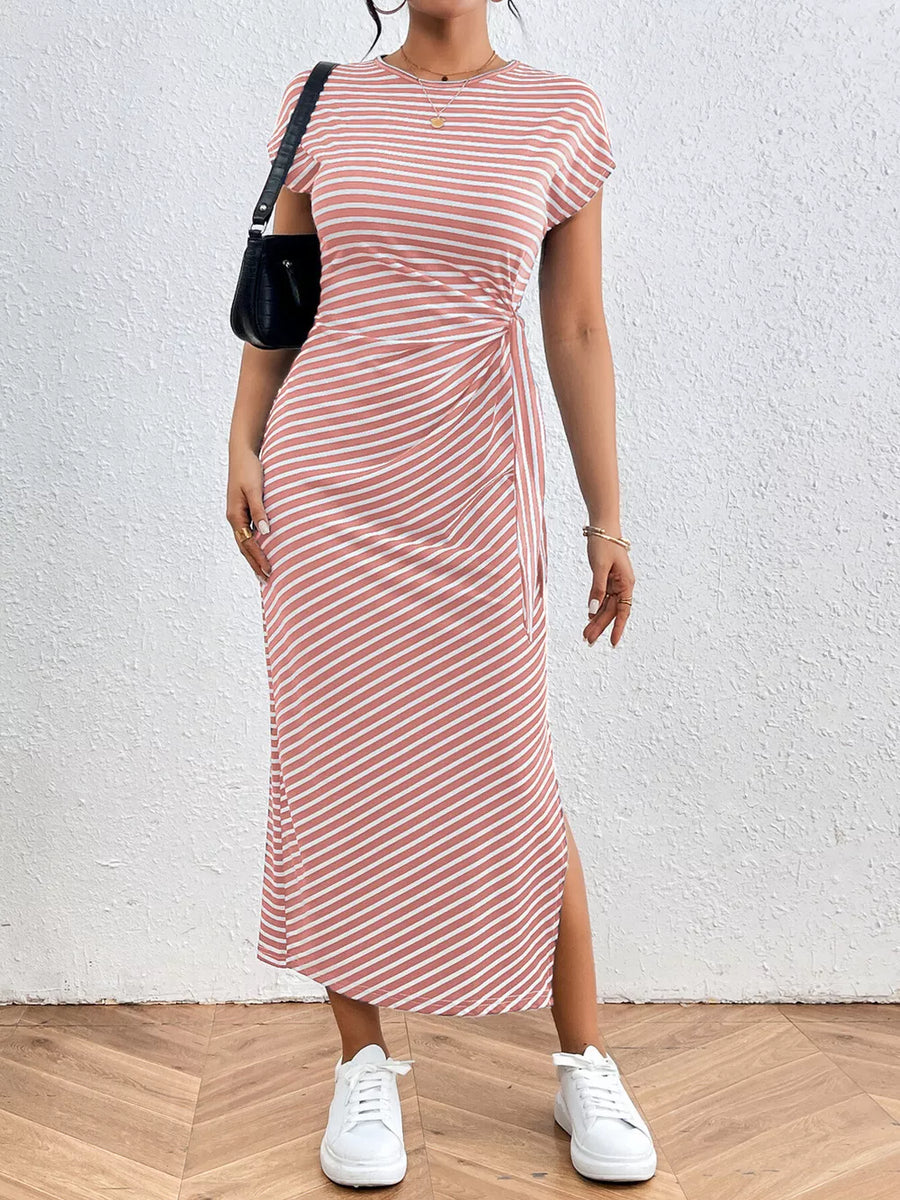 Pink striped midi dress with tie-side detail and thigh slit.