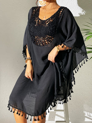 Black crochet yoke tassel kaftan dress with wide sleeves and fringed hem.