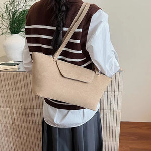 Sleek suede flap tote bag in khaki with a single shoulder strap.