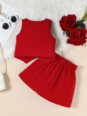 Red baby outfit with sleeveless top and pleated skirt, elastic waistband.