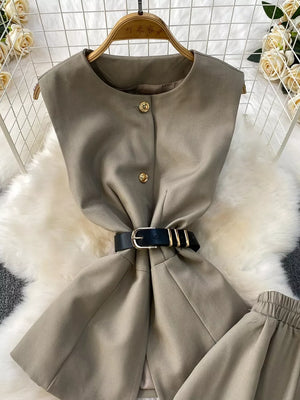 Mocha belted two-piece set with gold button detail and black belt.