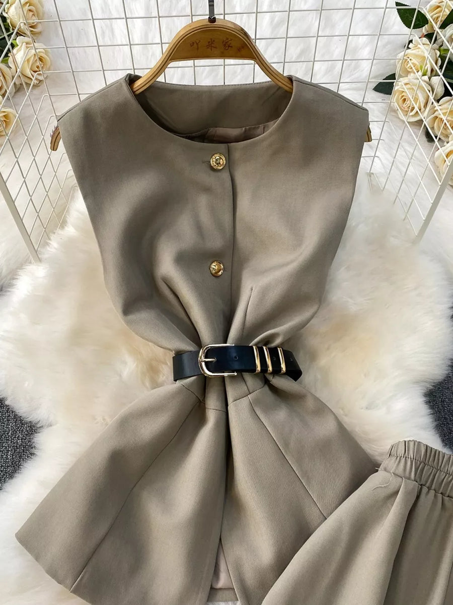 Mocha belted two-piece set with gold button detail and black belt.