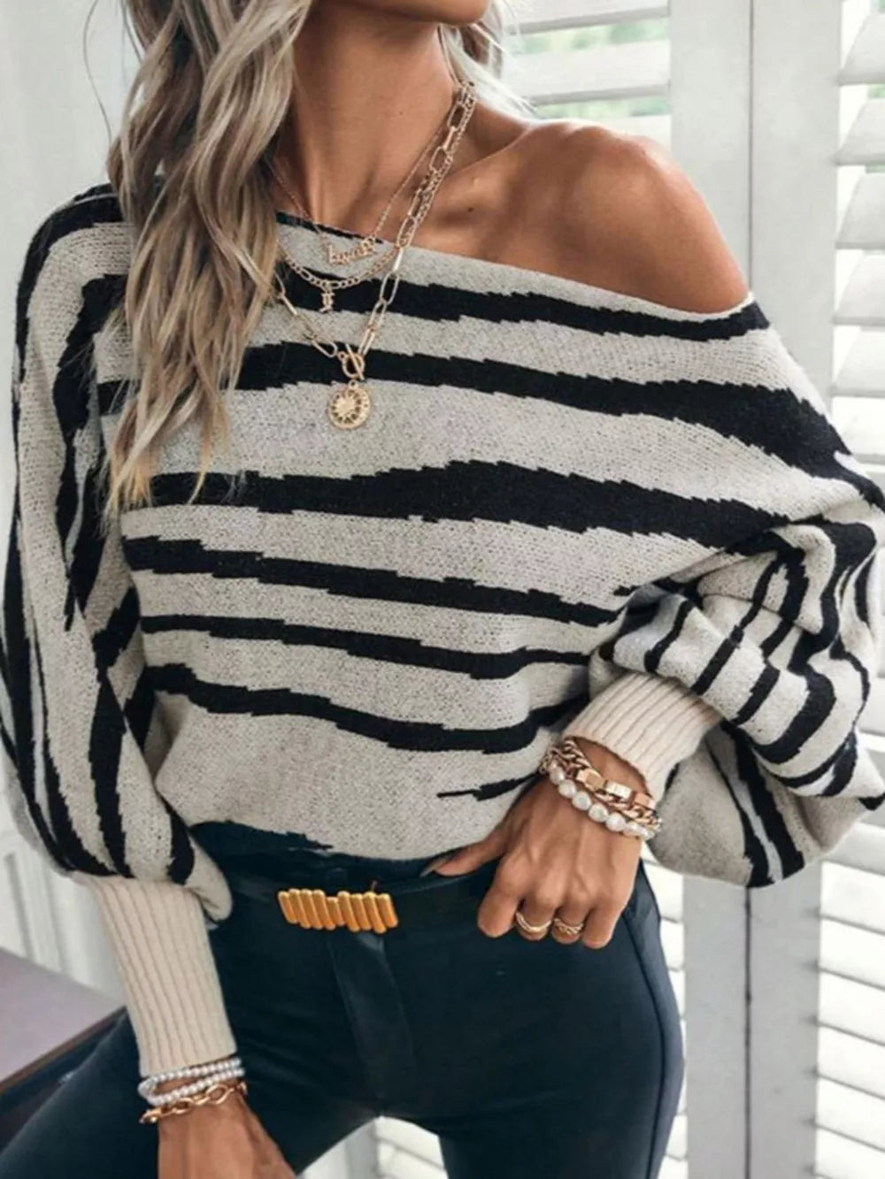 black pullover sweater with striped and off-shoulder