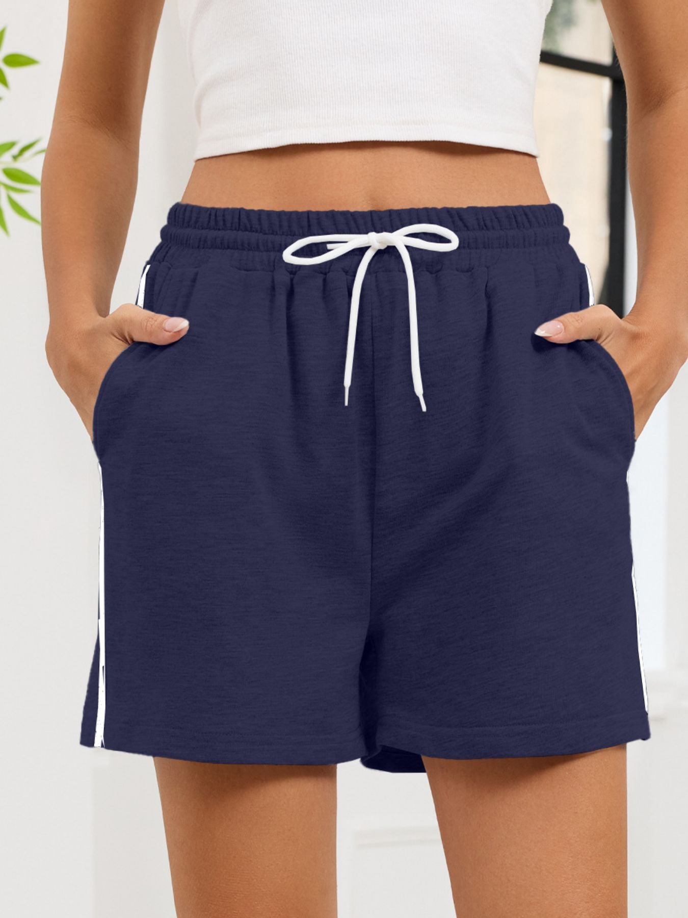 Navy heathered jogger shorts with white drawstring and sporty side trim.