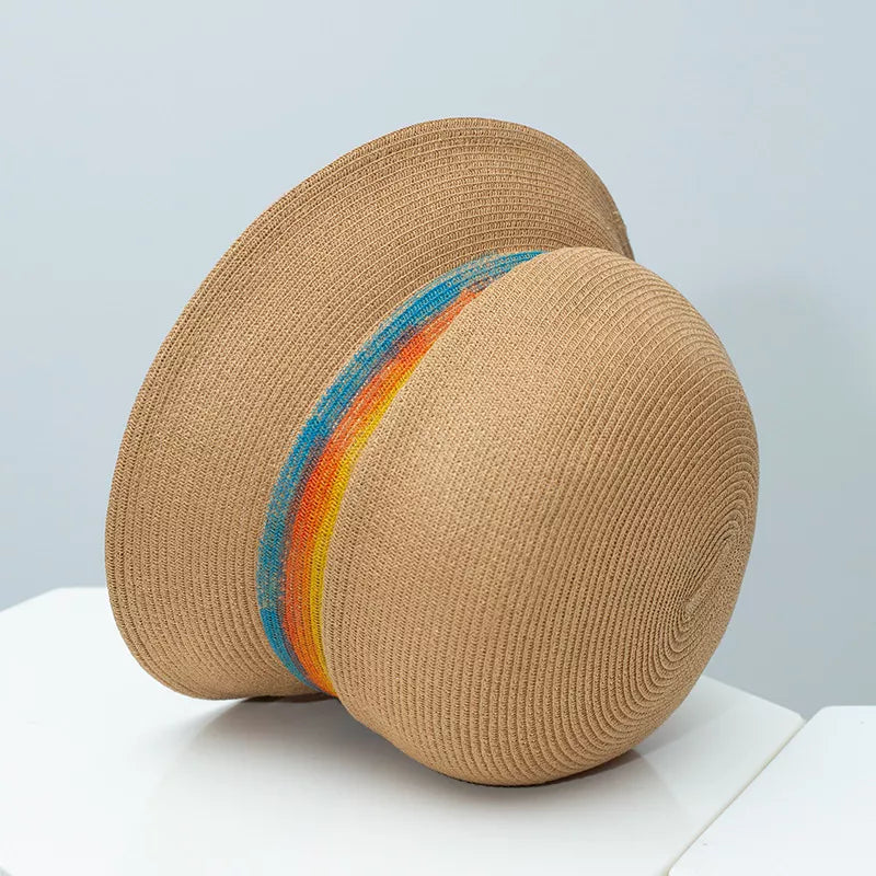 Beige straw cloche hat with a vibrant rainbow band detail
