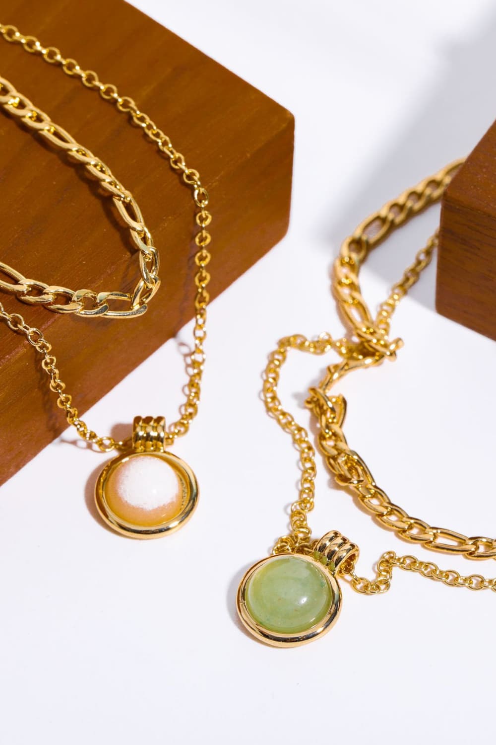 Gold necklaces with green and white aventurine orb pendants
