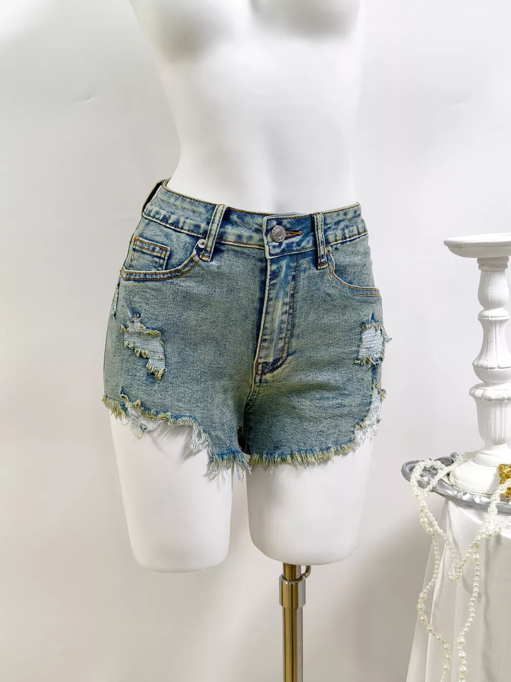denim shorts in light blue featuring distressed and regular fit